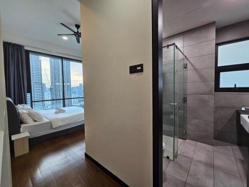 a bathroom with a shower and a bedroom with a bed at Opus Residences by Star Haven in Kuala Lumpur