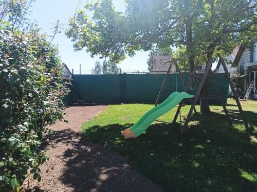 a swing in a yard with a tree at La Maison d'Emma, 10 p, grand spa, 1 h15 de Paris in Venon