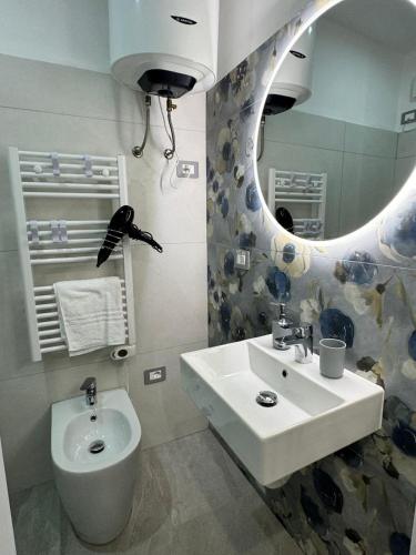a bathroom with a sink and a mirror at La Casa di Jennifer nel centro in Parma