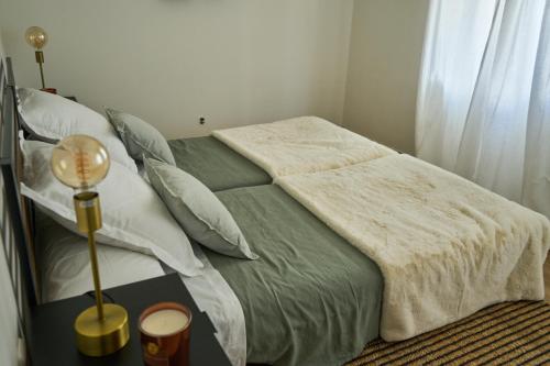 a bedroom with a bed and a lamp on a table at Habitacion amigos peregrinos in Irún