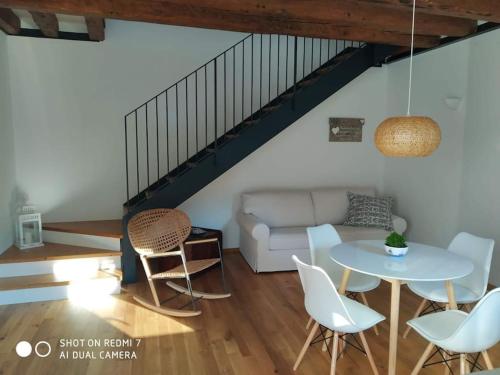 a living room with a table and chairs and a couch at Casa Martina, Confort e Relax a due passi da Cividale in Cividale del Friuli