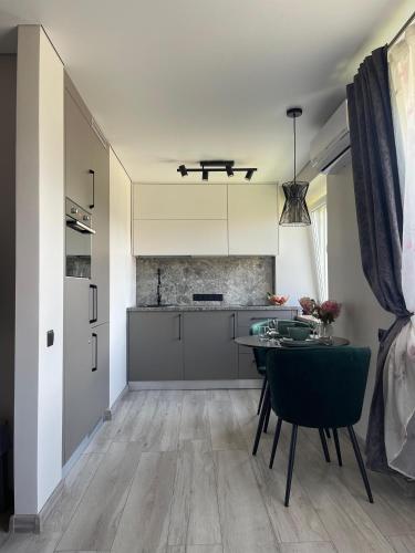 a kitchen with a table and chairs in a room at Few Steps to the Bay in Jūrmala