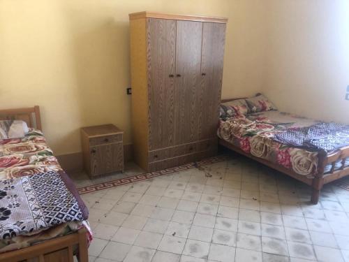 Ένα ή περισσότερα κρεβάτια σε δωμάτιο στο Saint Rita Guest House Alex