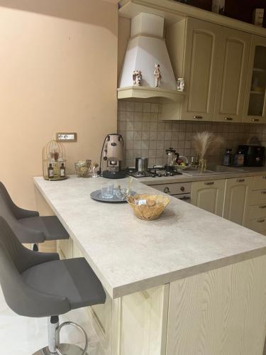 a kitchen with a counter with a bowl on it at B & B Temptation Airport Fontanarossa shared house with several rooms in Catania