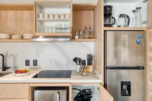 Η κουζίνα ή μικρή κουζίνα στο Caliza Roma Residences by Tasman