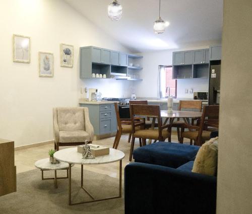 a living room and kitchen with a table and chairs at Hotel Pietro Santo in Santeagueda