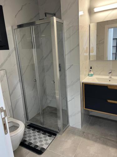 a bathroom with a shower and a toilet and a sink at Caesar Resort Didious in Iskele