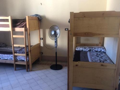 Ένα ή περισσότερα κρεβάτια σε δωμάτιο στο Saint Rita Guest House Alex