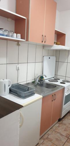 a small kitchen with a sink and a stove at city center apartment 1 in Niš