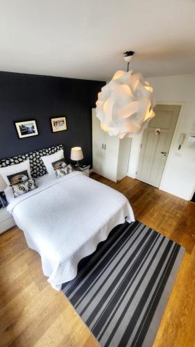 a bedroom with a large white bed and a chandelier at Velvetamsterdam in Amsterdam