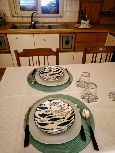 a table with plates and napkins on top of it at Adelia House in Catania