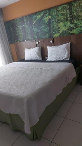 Postel nebo postele na pokoji v ubytování Flat com varanda, quarto de Morador Hotel 1112