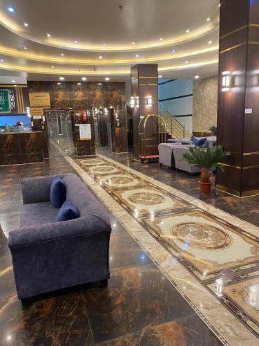 a lobby with a couch in the middle of a building at شقق راحتي جازان للشقق المخدومة in Jazan