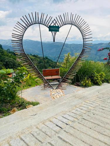a bench in the shape of a heart at Entre Verdes Hotel & Glamping in Medellín