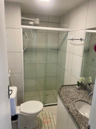 a bathroom with a shower and a toilet and a sink at Smart Residence flat 803 in Teresina