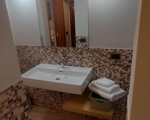 a bathroom with a white sink and a mirror at Il Micco in Pistoia