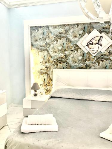 a bedroom with a bed and a wall mural at Al chiaro di luna in Catania