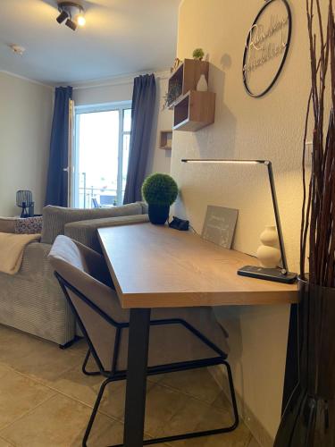 a desk in a living room with a couch at Duke-Fewo am Meer im Haus Atlantic beim Kurpark in Grömitz