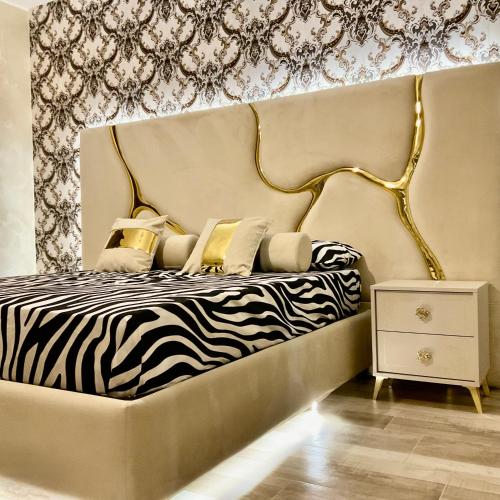 a bedroom with a bed with a zebra print wall at Al chiaro di luna in Catania