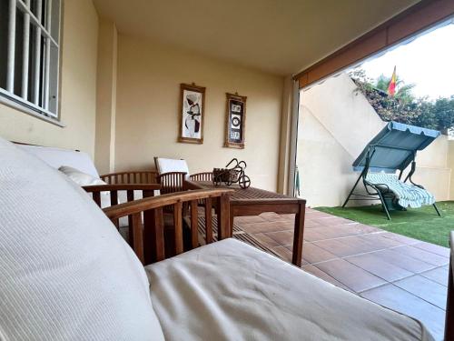 a room with a bed and a balcony with a piano at Almerimar Amplio Apartamento de 3 Habitaciones con Piscina, pista de padel, futbol y Garaje Cubierto para 2 Coches en Altas Entinas in Almerimar