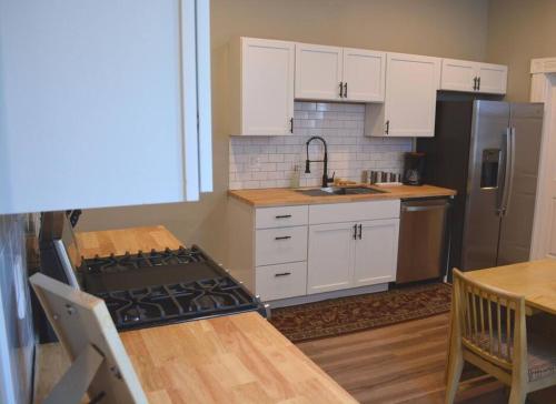 a kitchen with white cabinets and a stove top oven at Eco Friendly Home by Cincy w Office Space in Dayton