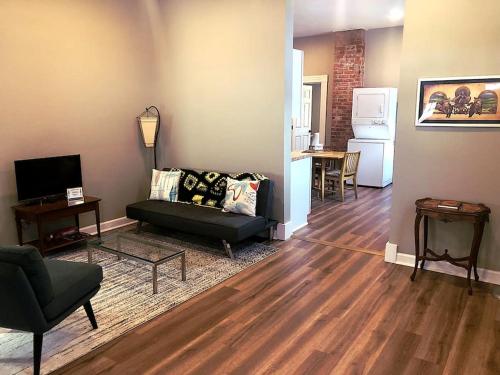 a living room with a couch and a table and a kitchen at Eco Friendly Home by Cincy w Office Space in Dayton