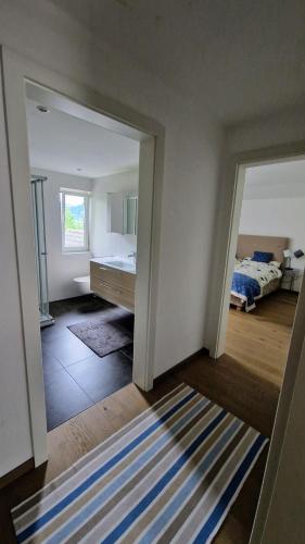 a room with a bedroom with a bed and a rug at Haus Montis in Haus im Ennstal