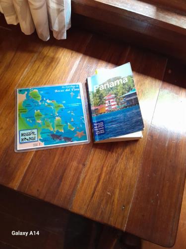 two magazines sitting on top of a table at Hostal Hansi in Bocas del Toro