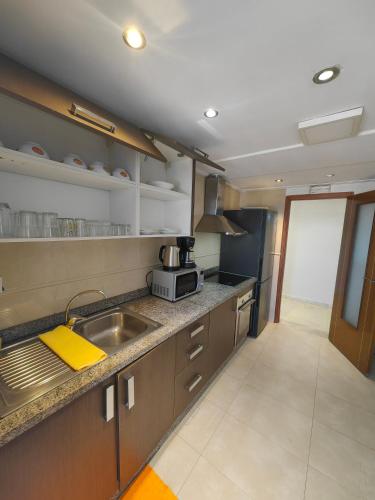 a kitchen with a sink and a microwave at City Bleu Maroc in Tangier