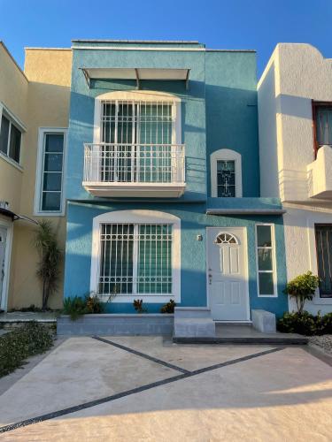 a blue house with a white door and windows at Casa Azul en Cancún in Cancún