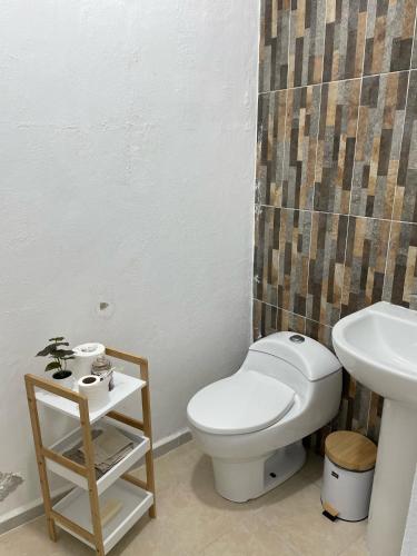 a bathroom with a toilet and a sink at Casa Azul en Cancún in Cancún