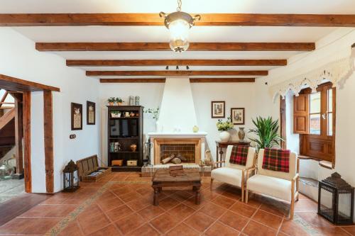 a living room with a fireplace and wooden ceilings at Home2Book La Casita del Muelle in Garachico