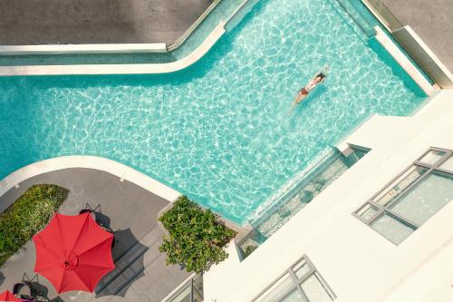 an overhead view of a person swimming in a swimming pool at Novotel Suites Manila Aqua Residences Near Makati by Hamodi'sCrib in Manila