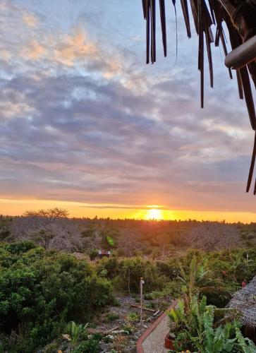 a sunset from the porch of a house at MONKEY MOUNTAIN LODGE in Mtende