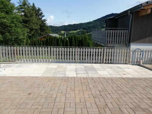 a wooden fence in front of a house at Le Logis du Chalet Perce-Neige in Châtel-Saint-Denis