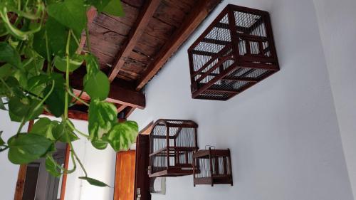 a group of bird cages hanging on a wall at Home2Book La Casita del Muelle in Garachico