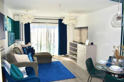 a living room with a couch and a table at Hemel Apartments - Riverside Retreat in Hemel Hempstead