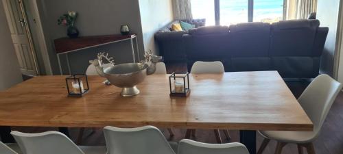 a dining room table with a bowl on top of it at Beach House Margate in Margate