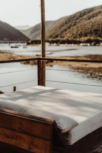 a bed sitting on the side of a boat at Stanley Island in Plettenberg Bay