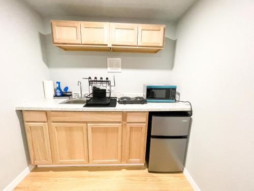 a kitchen with wooden cabinets and a counter top at Beautiful room in prime location in Pinellas Park
