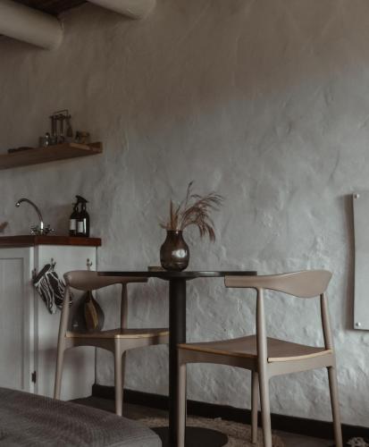 a dining room with a table and two chairs at Stanley Island in Plettenberg Bay