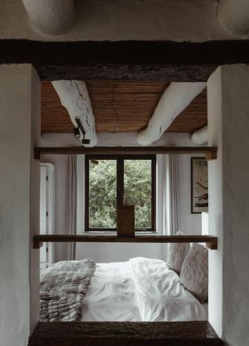 a bedroom with a bed and a window at Stanley Island in Plettenberg Bay