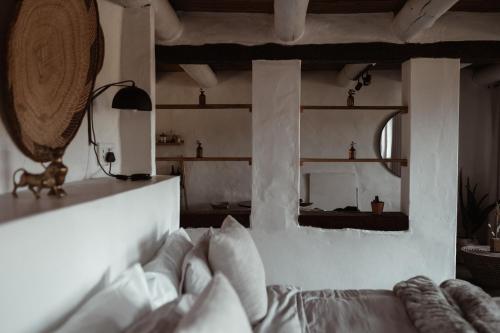 a living room with a bed and a mirror at Stanley Island in Plettenberg Bay