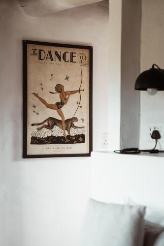 a picture of a woman with a bow and arrow on a wall at Stanley Island in Plettenberg Bay