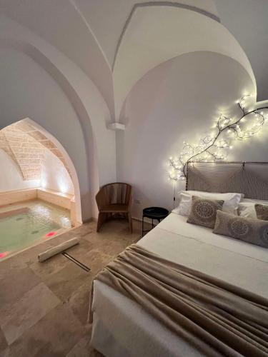 a bedroom with a bed and a swimming pool at Zahra Superior Suite with private pool in Sannicola