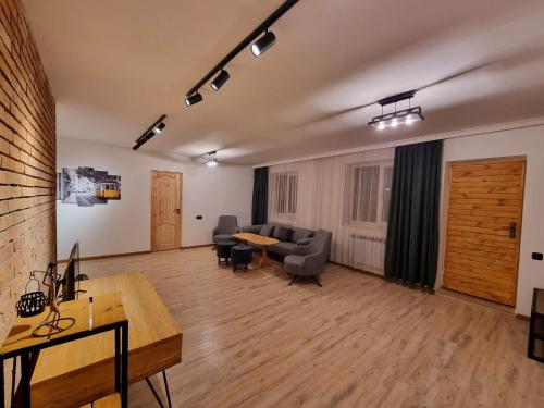 a living room with a couch and a table at Villa Sunshine ,apartment with 4 bedrooms ,whole apartment, апартаменты целиком in Dilijan
