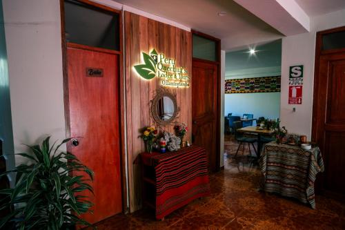 a room with a door with a table and a mirror at PERU QUECHUA'S LODGE Riverside in Ollantaytambo