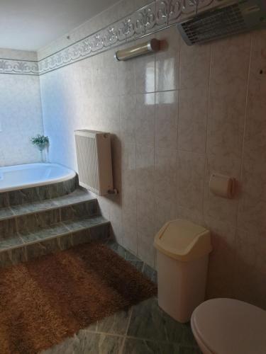 a bathroom with a toilet and a sink and a tub at Beautiful spacious house with swimming pool in Limassol
