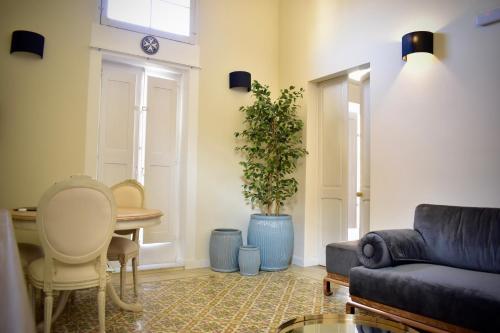 a living room with a couch and a table at Grand Arcanum Apartment 2 - Comfortable and Elegant in Senglea