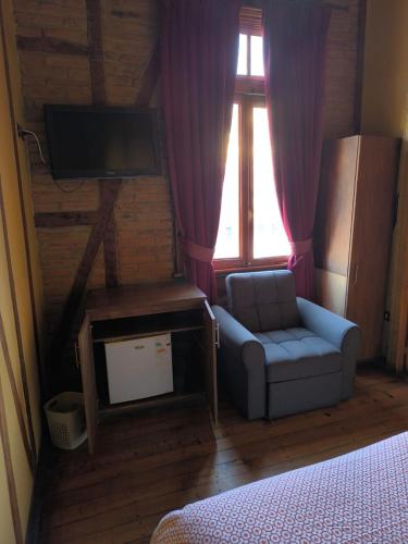 Кровать или кровати в номере Hotel Reina Victoria Valparaíso